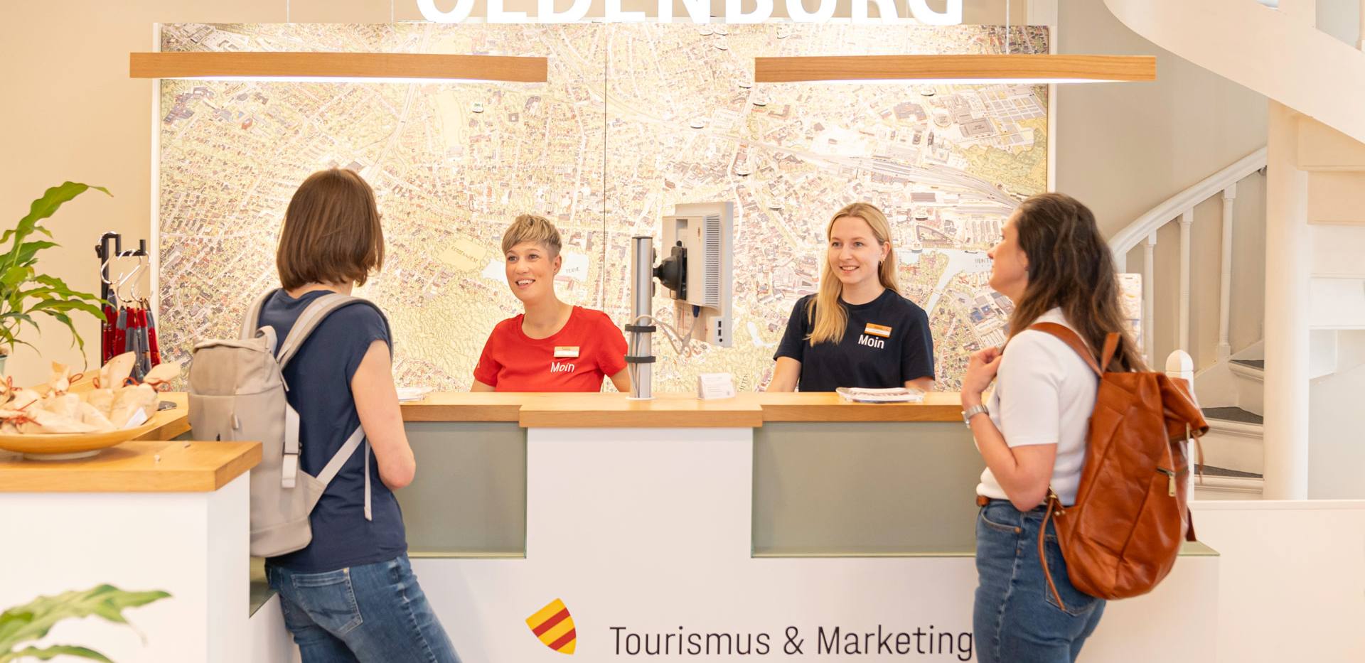Zwei Gäste werden in der Touristinfo in Oldenburg beraten