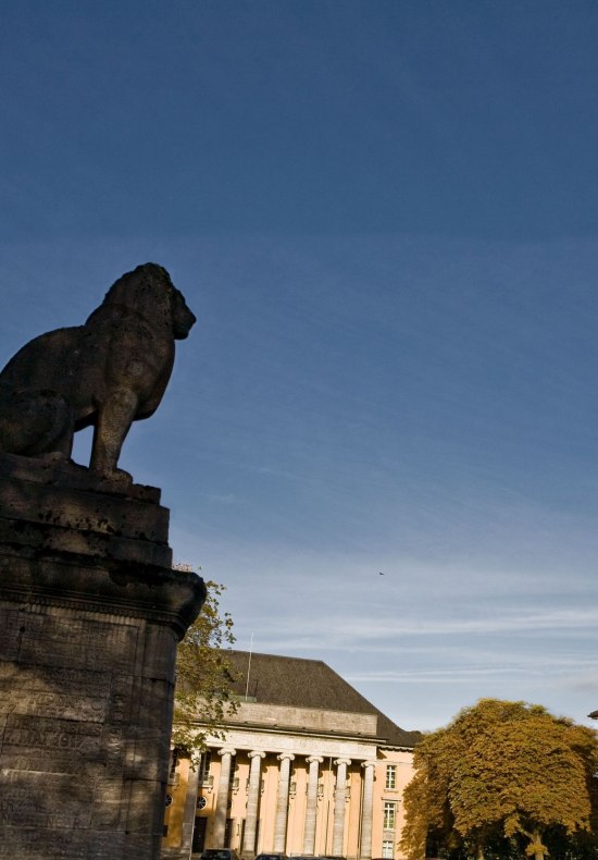 Blick auf das Gebäude "Alter Landtag" mit Löwenstatue im Vordergrund.